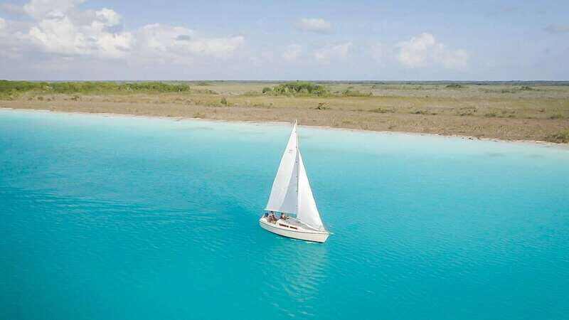 Bacalar: Group Sailing Trip with Swimming and Drinks - Cenote Esmeralda: First Glimpse, Then the Main Attraction