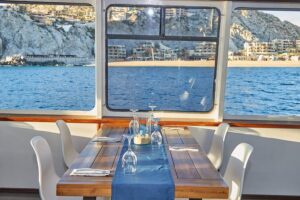 Cabo Sunset Dinner Cruise with Live Music & Open Bar on Cabo Wave - Stop 1: Chasing the Arch of Cabo San Lucas From the Upper Lounge