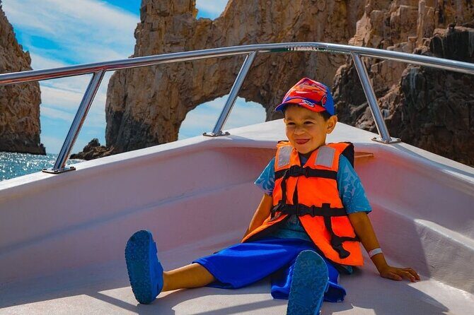 Glass-bottom boat tour to the Arch + beach time - Lover’s Beach from the bay: the “good seats” advantage