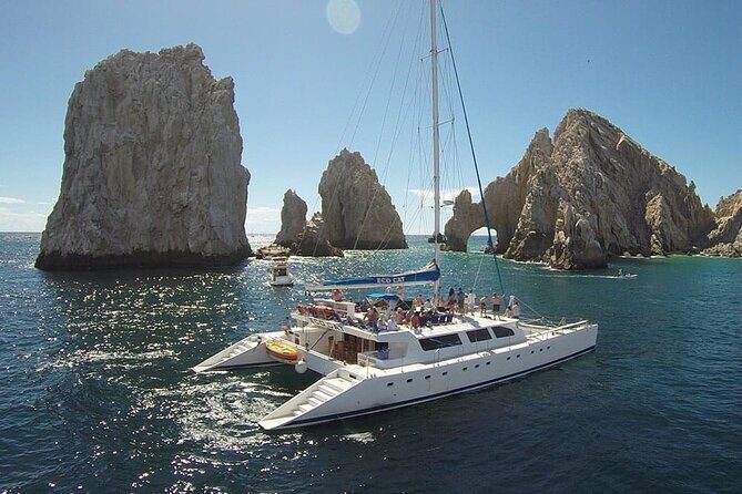 Multimillion Yacht Cabo Cruise Sunset or Snorkel Optional PICKUP! - What This Cabo Cruise Feels Like: arch views plus a drinks-and-music mood