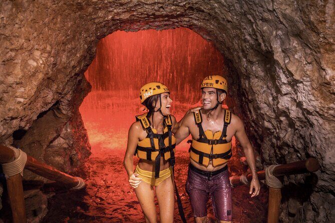 Xplor Fuego Admission <em>Official Product</em> – The Stalactite River Swim and Underground Paddling’ /><br />
The heart of Xplor Fuego is the underground water adventure. You’ll swim through areas connected to the <strong>stalactite river</strong>, and you’ll paddle through <strong>underground chambers</strong> illuminated with colorful lights. You float close to a cavern roof, with stalactites overhead—so the visuals are part of the experience, not just background.</p>
<p><p>The raft portion is a great way to slow down after the adrenaline. It gives you time to look at rock formations and take in the lighting, instead of constantly reacting to height or speed. It’s also one of the moments where your clothing choices matter a lot: you’ll be wet, and you’ll want shoes that can handle water safely and comfortably.</p>
</p>
<p><p>Fitness note: you’ll want <strong>moderate physical fitness</strong>. You don’t need to be an athlete, but you should be comfortable moving while wearing a life jacket and doing water-based activity.</p>
</p>
<h2 id="caves-caves-everywhere-why-the-underground-part-feels-special">Caves, Caves Everywhere: Why the Underground Part Feels Special</h2>
<p><img width="669" height="446" decoding="async" src=